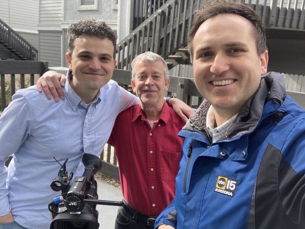 three men smiling