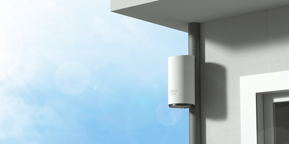 a photo of TP-Link Deco BE65-Outdoor installed outside a home.