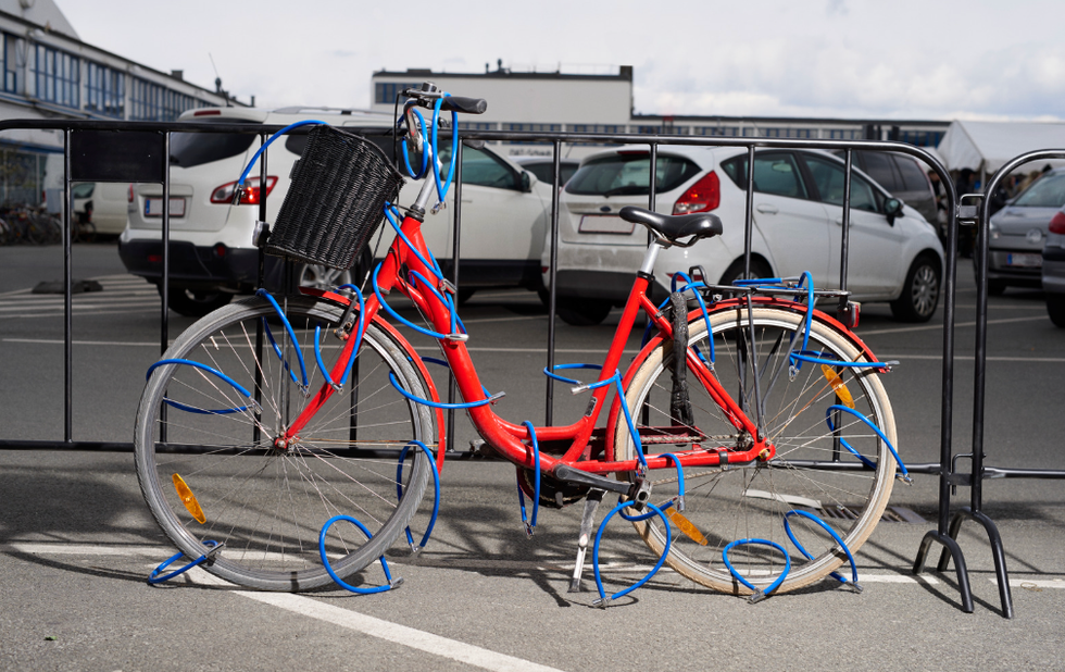 A bike with multiple bike locks on a gate