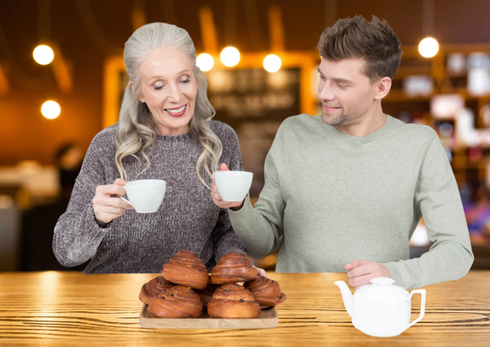 An older woman and younger man having coffee and pastries together in a cafe