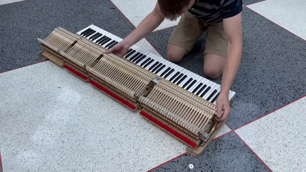 The Piano Doctor mid-surgery: Josiah Jackson takes the instrument apart.