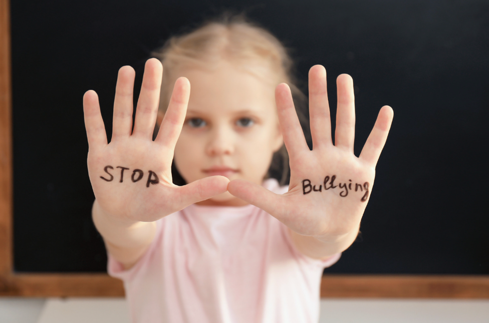 Girl with "stop bullying" written on her hands