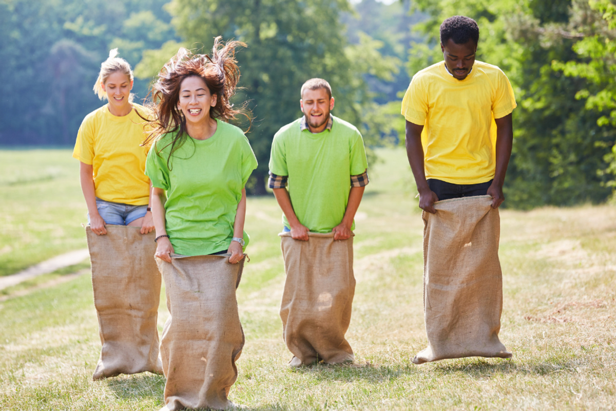 People in a potato sack race outside