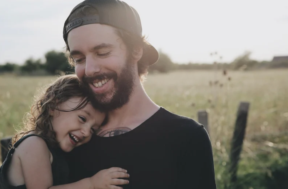 Dad hugging daughter