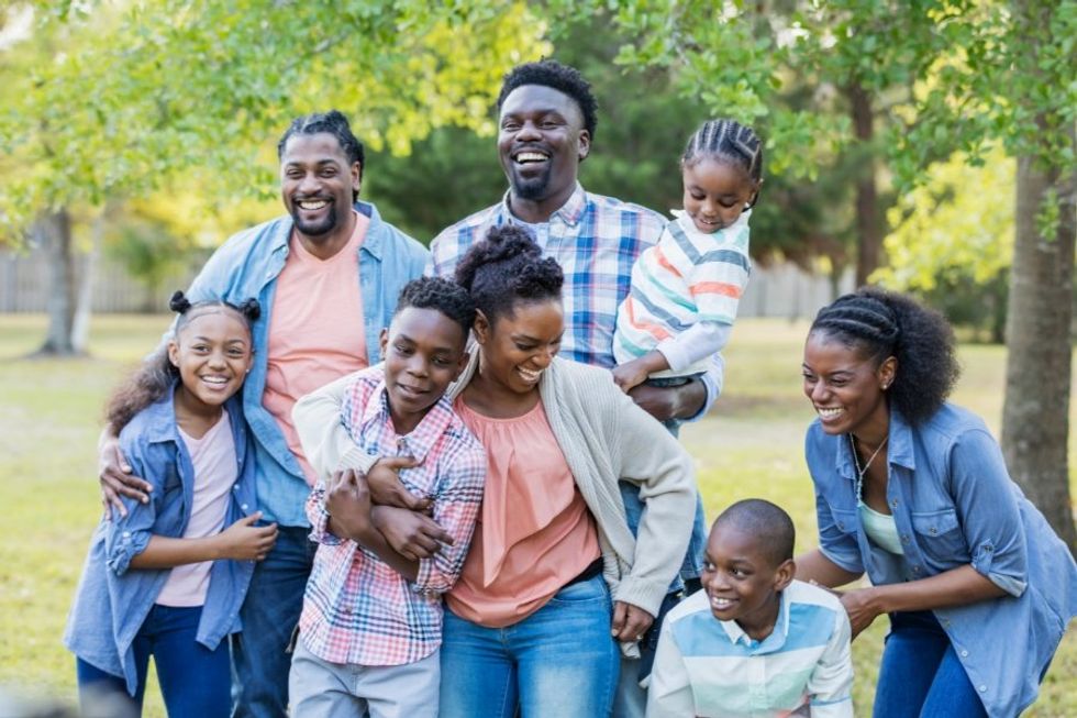 large family laughing while taking a photo