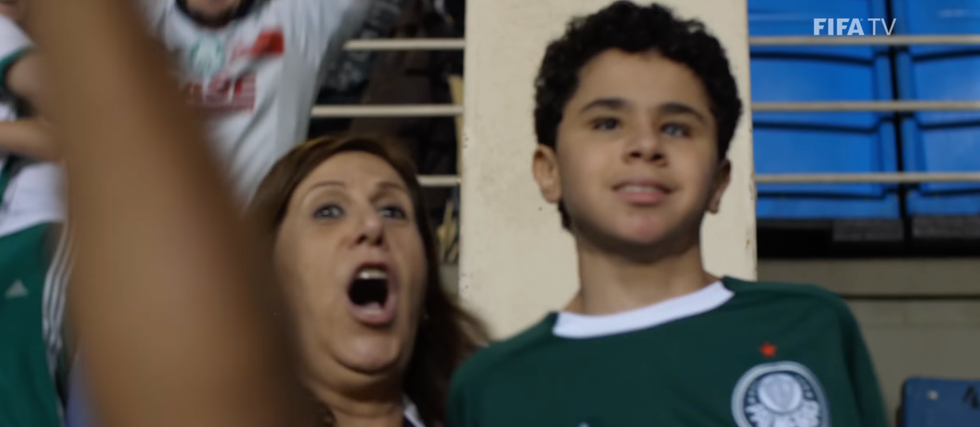 Silvia Grecco and her son Nikollas celebrating a soccer goal.