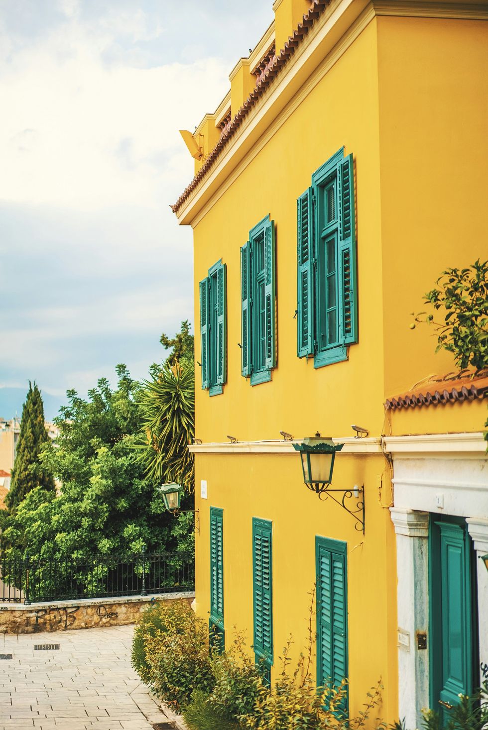 Yellow house with green shutters