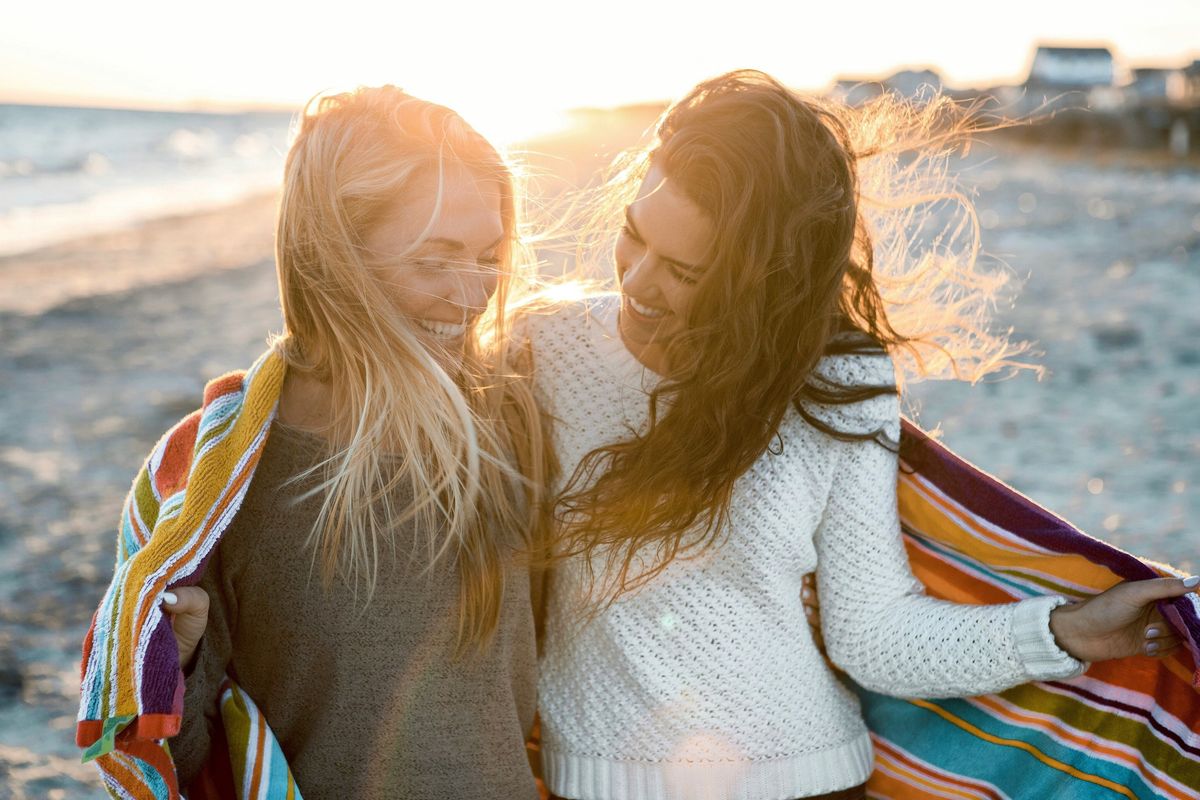 two women walking on the beach