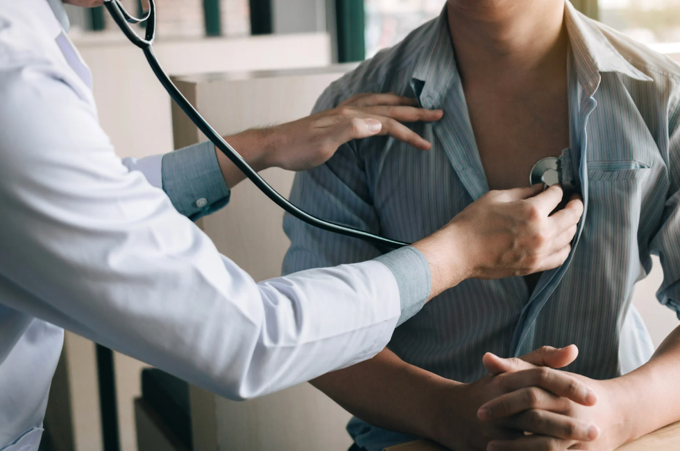 Doctor checking a person's heart with a stethoscope