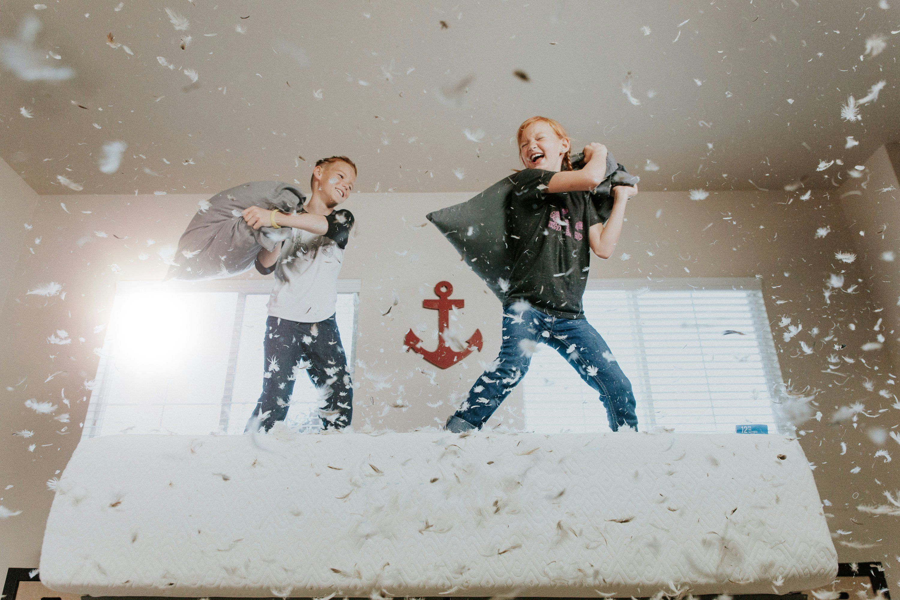 two boys having pillow fight