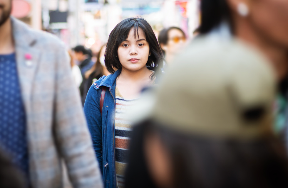 Woman alone in a crowd