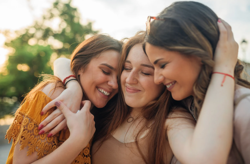 Woman hugging two women