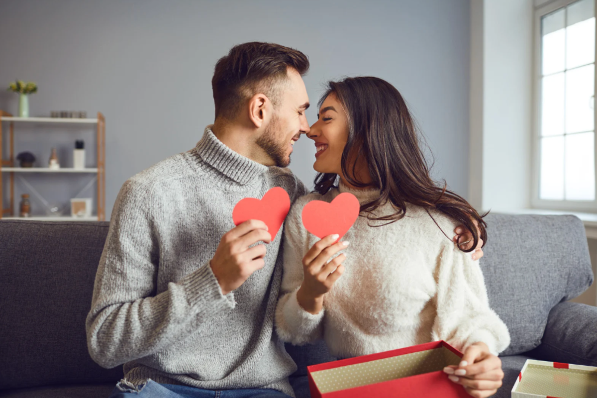 Man and woman with paper hearts