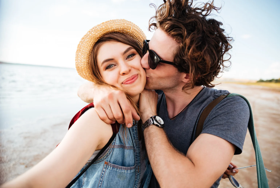 Man kissing woman on the beach