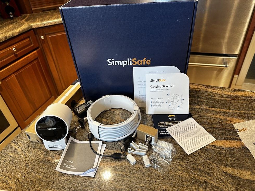 a photo of SimpliSafe Outdoor Security Camera Series 2 with Active Guard unboxed on a counter.
