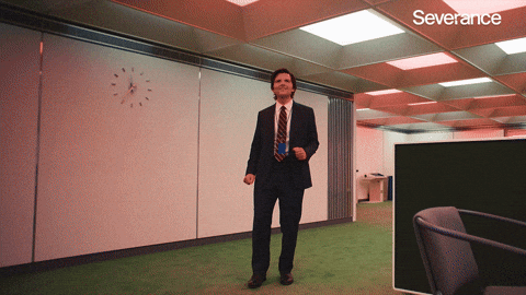 Man joyfully dancing in an office with a clock on the wall, labeled "Severance."