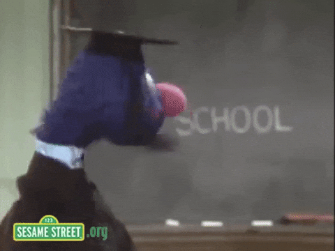 gif of Grover from Sesame Street in a cap in gown reading a blackboard that says "School"