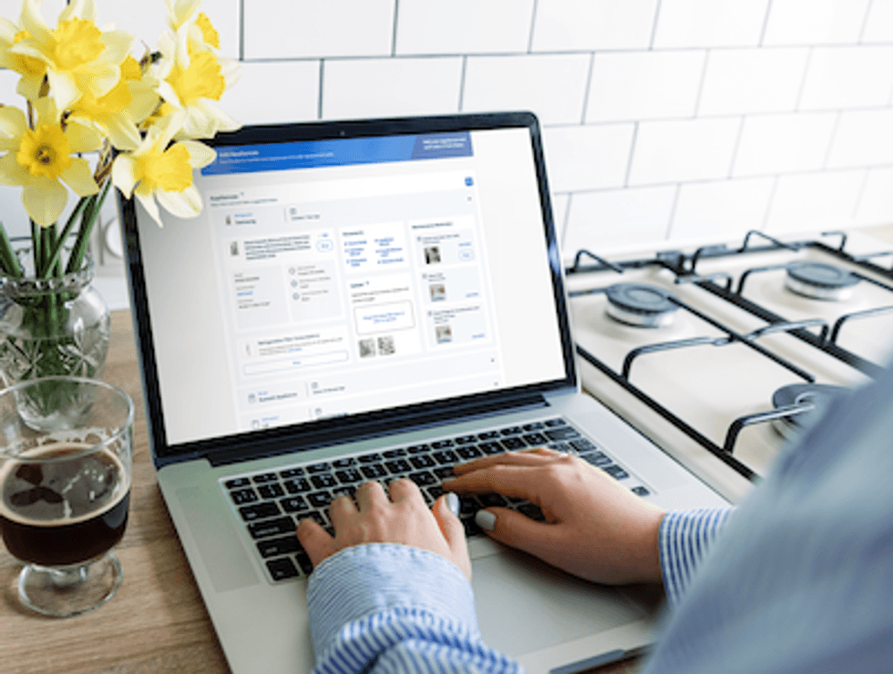 a photo of a person on a laptop using Lowe's Mylow virtual assistant