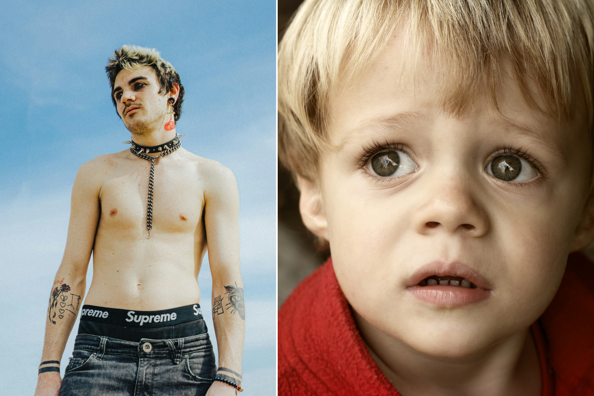 young shirtless "goth" man with eye makeup, tattoos, a spiked collar, plugs, and frosted hair; a little boy looking sad