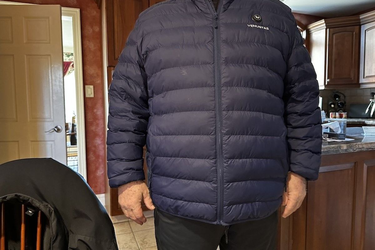 a photo of a male wearing a Venustas Men’s Heated Lightweight Puffer Jacket 7.4V