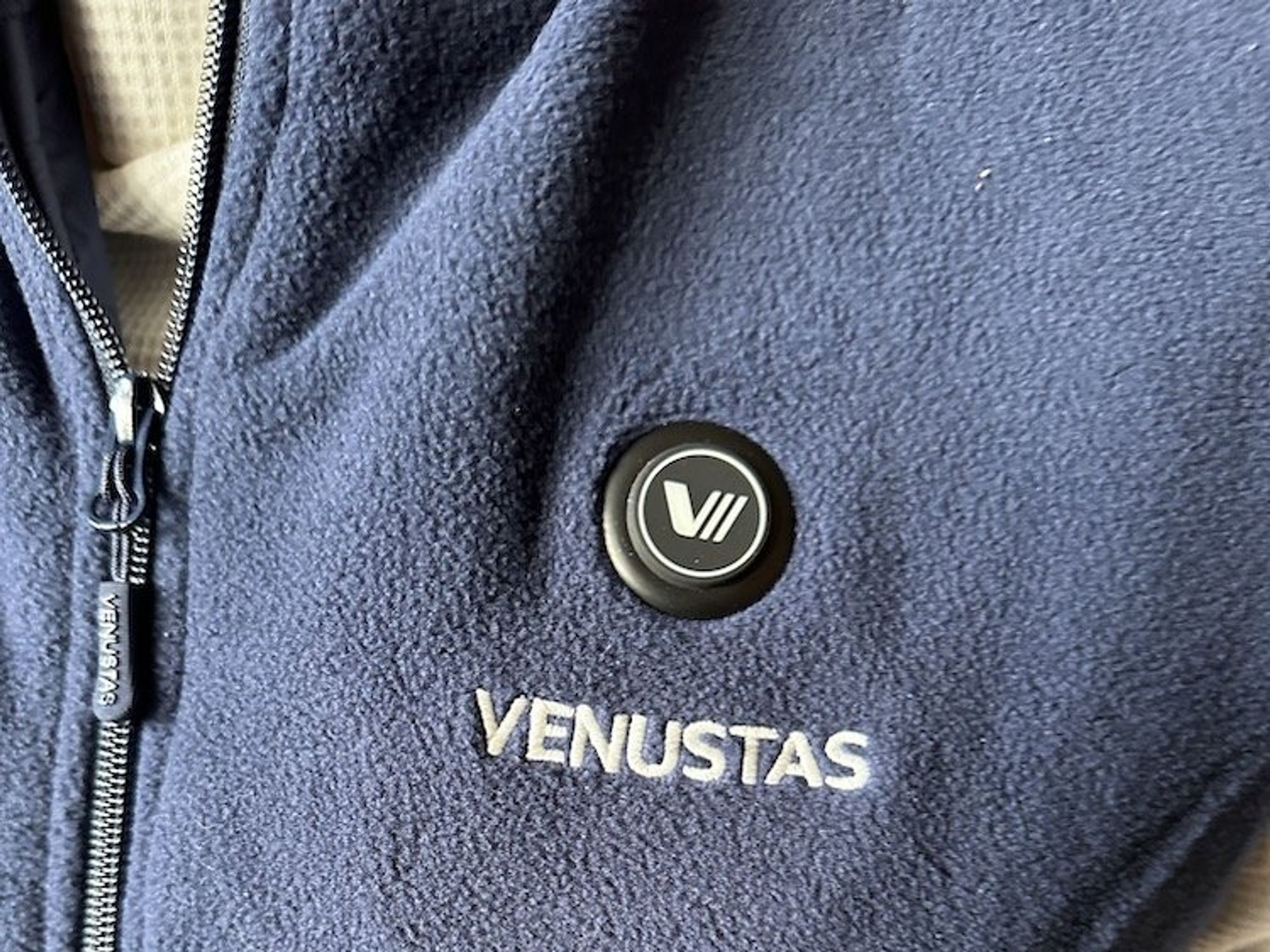 a photo of Venustas Women's Heated Fleece Vest and the button to control the heat