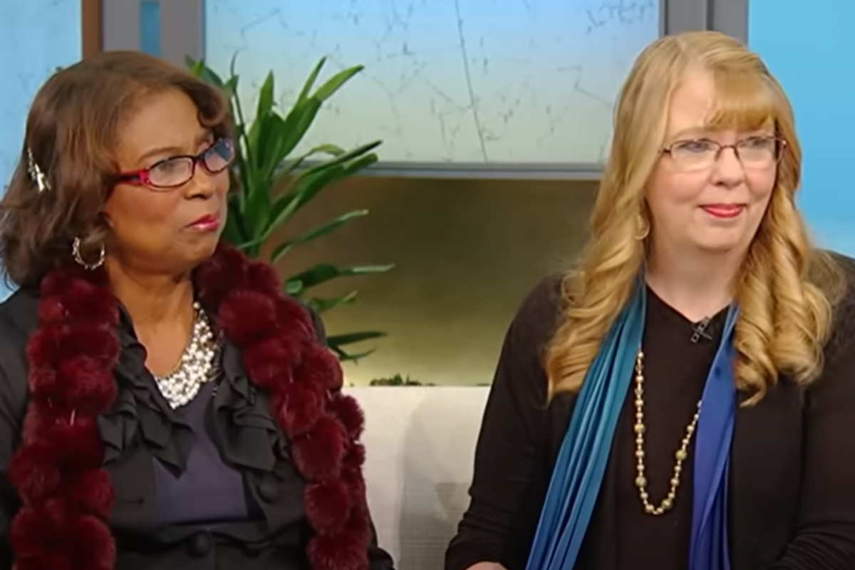 two women sitting on a couch at a talk show