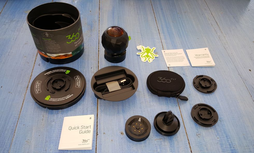 Picture of 360fly camera on a table with accessories.