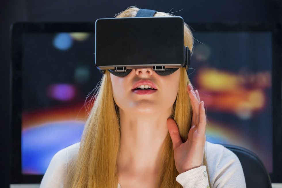 a photo of a woman wearing a VR headset