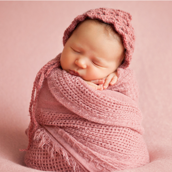 baby swathed in pink blanket