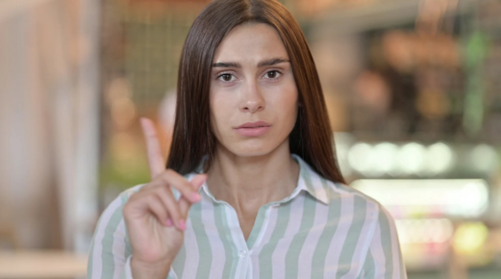 woman says no, woman raises finger, no kids, childfree, independant woman, millennial