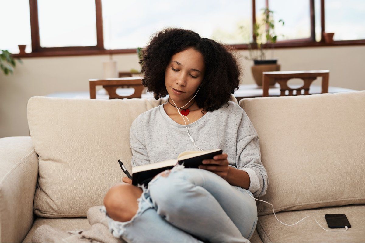 woman writing in a journal, gratitude journal, contributions journal, adam grant