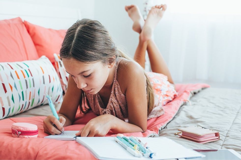 girl writing a note, kindness diary, acts of kindness, irish school