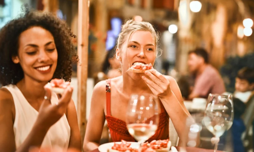 woman eating, early dinner, italian food, bruschetta, wine glasses, happy hour, dinner