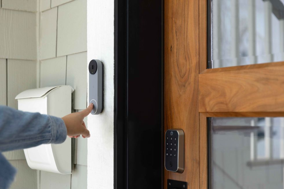 a person ringing a doorbell with a front door that has Yale Assure Lock 2 Touch with Z-Wave 800 Series 