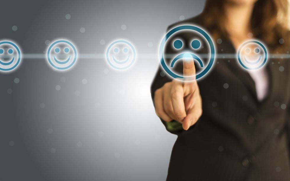 Businesswoman giving rating with sad icon stock photo