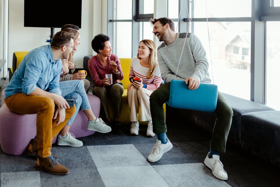 Colleague Taking Break in Modern Office Break Out Area stock photo