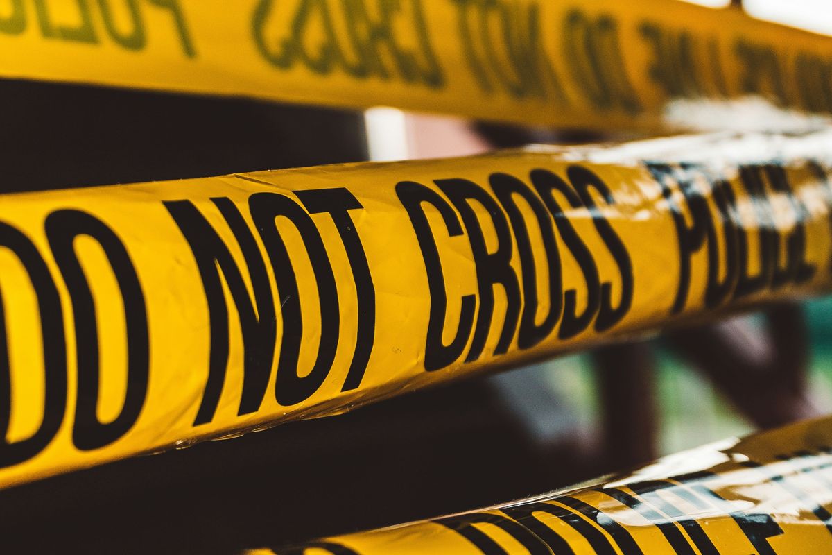 Yellow "Do Not Cross" police tape in a close-up view.
