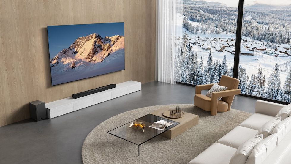 photo of a room with TCL Smart TV on the wall and Q65H soundbar
