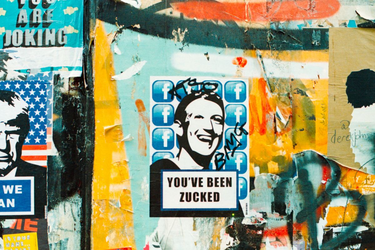 Graffiti collage with "YOU'VE BEEN ZUCKED" poster on colorful wall.