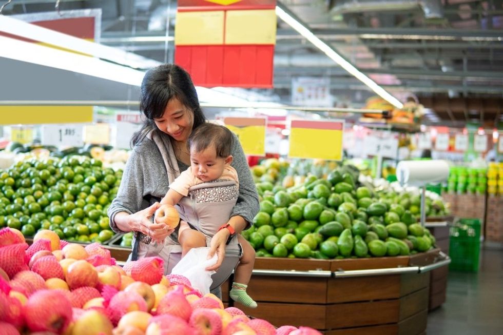 mom carrying baby, mom in grocery store, motherhood, babies