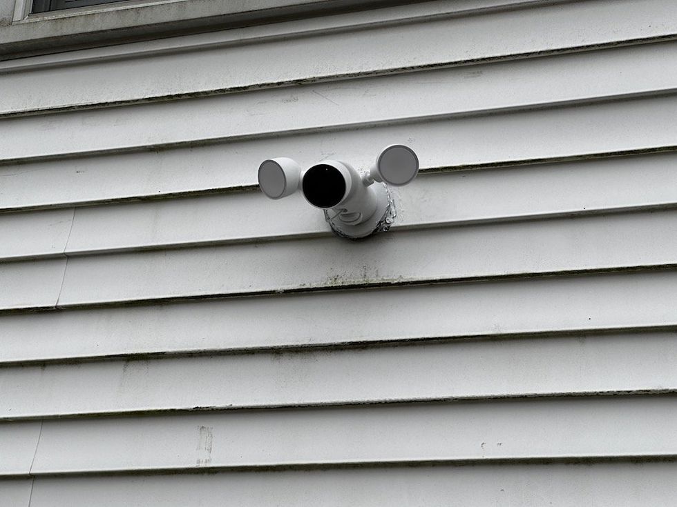 Photo of Google Nest Floodlight installed high up on a house