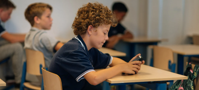 smartphone, student, student cellphone, desk, classroom, staring at phone