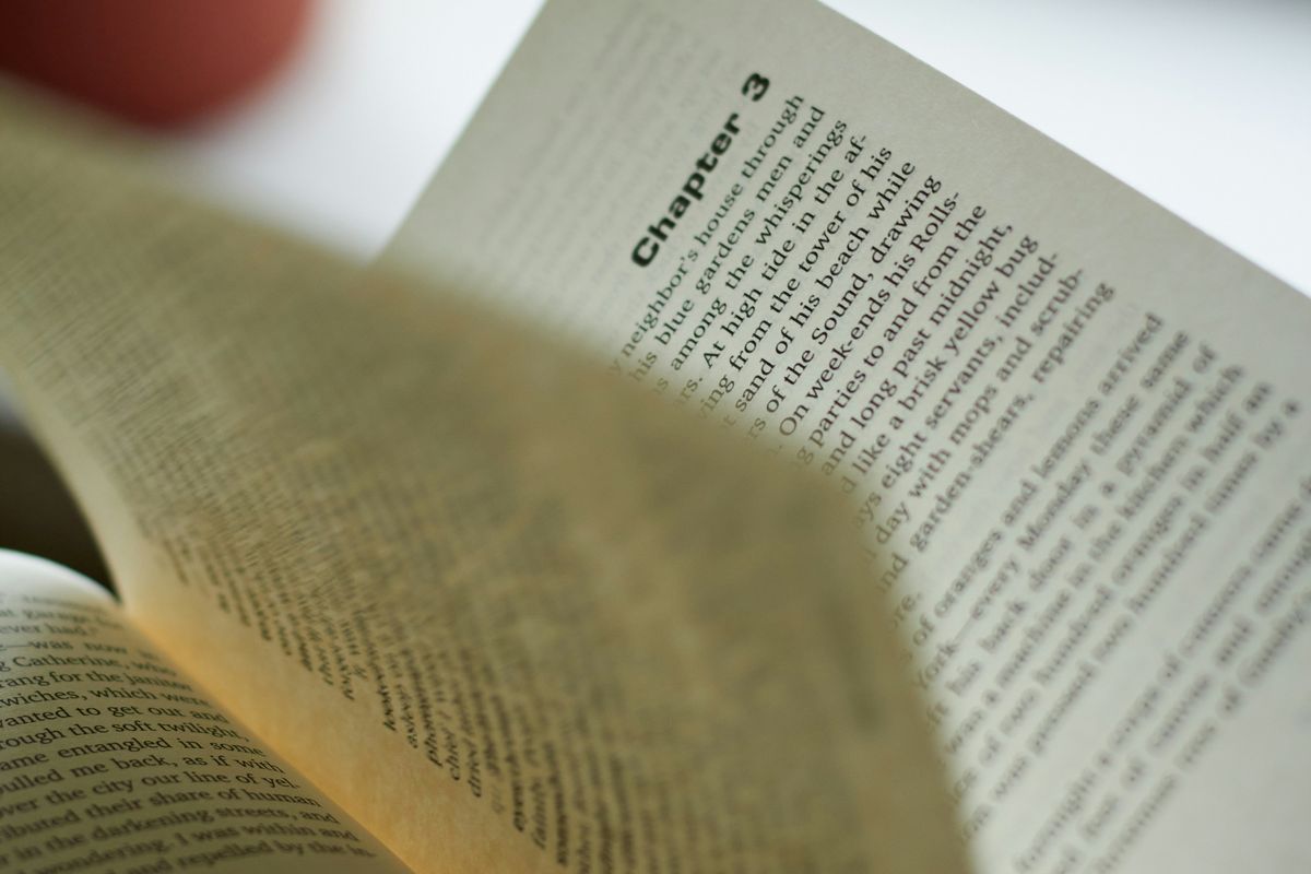 Open book showing Chapter 3, with soft lighting in the background.