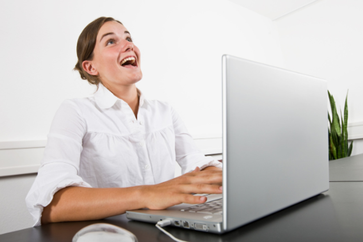 woman laughing, laughing at computer, online dating, blonde woman, young woman