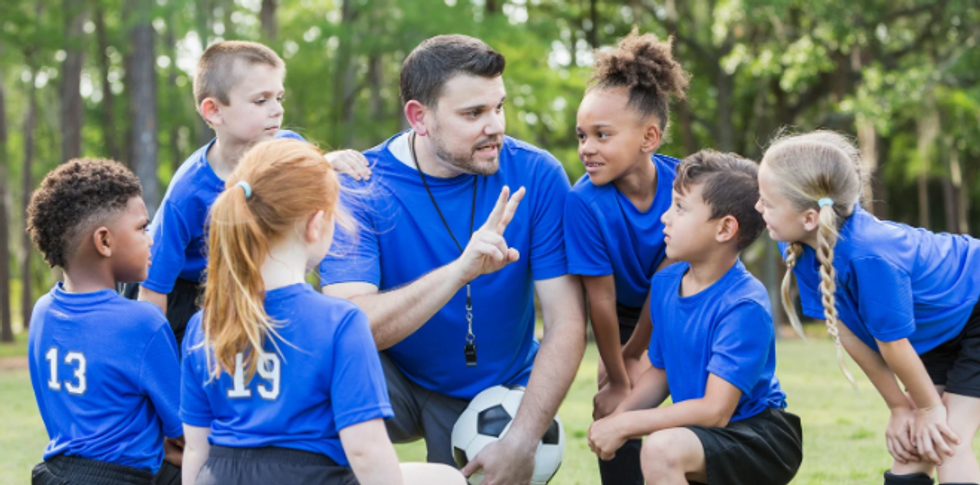 soccer coach, co-ed soccer team, young girls and boys, coach and kids, sports