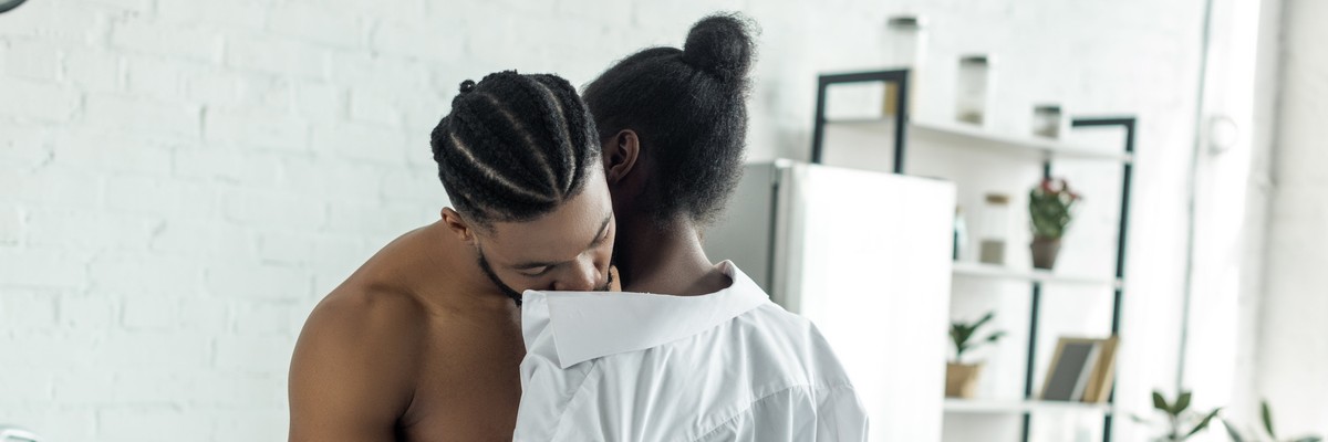 cropped image of african american lovers in morning at kitchen