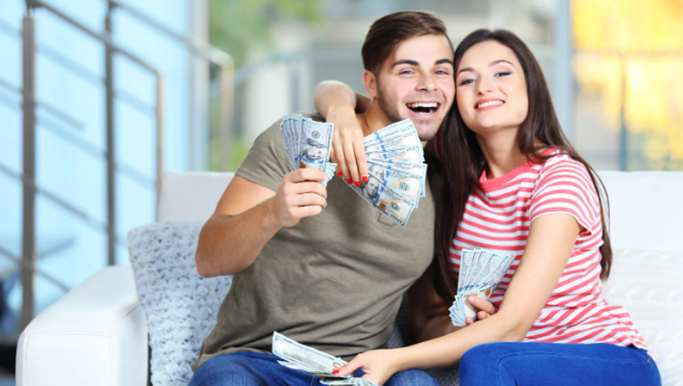 couple with money, middle class money, cash money, couple on couch, man and woman