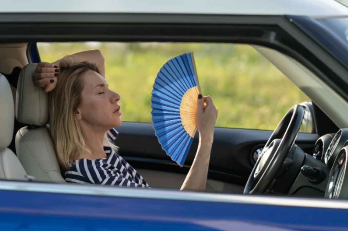 hot car, cool car, woman with fan, summer car, summer heat, sweating,