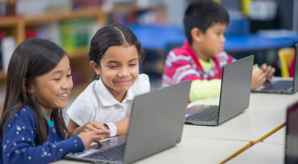 children, children and computers, laptops, smiling girls, classroom, two girls and a laptop,