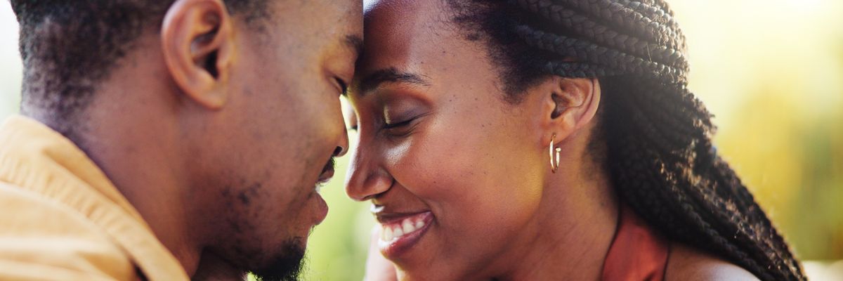 Love, forehead touch and black couple in park together for bonding, relationship and affection in nature. Relax, dating and happy man and woman outdoors for romance, embrace and commitment on weekend